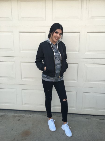 gray graphic hoodie with black Nike windbreaker and sweatpants
