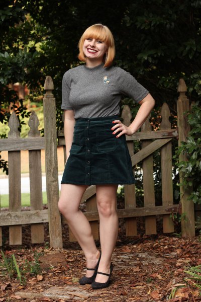 Gray fitted t-shirt with half sleeves and black high rise mini skirt