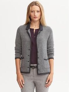 gray knitted blazer with black top and skinny pants made of cotton