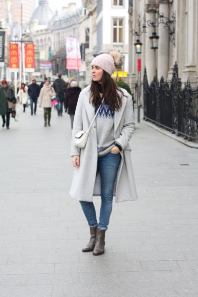 gray knit hat and matching long winter coat and cuffed jeans