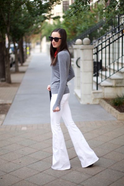 Gray long sleeve fitted t-shirt with white flared jeans