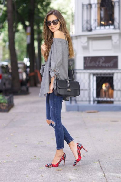 Gray off the shoulder blouse with blue ripped ankle jeans and plaid shoes