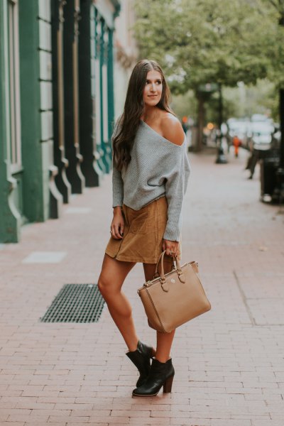 Gray chunky one shoulder sweater with tan mini skirt