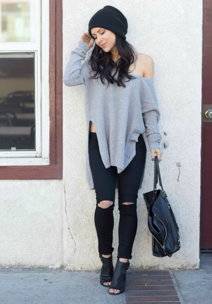 Gray side slit tunic sweater with one shoulder and ripped jeans