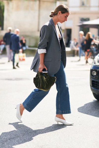 Gray oversized blazer with blue jeans and white kitten heel pumps