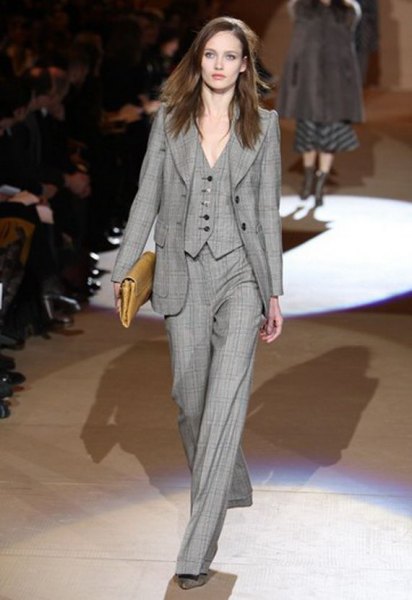 gray plaid suit with baggy pants and brown leather clutch