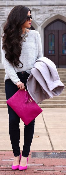 gray sweater with pink clutch handbag