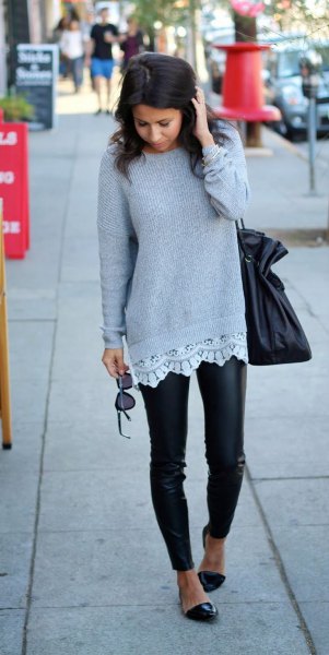 gray ripped sweater with white tunic blouse and leather tights