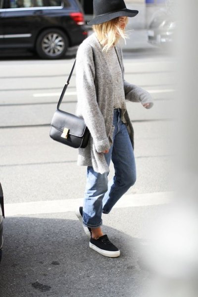 Gray sweater cardigan with blue boyfriend jeans and black and white slip-on shoes
