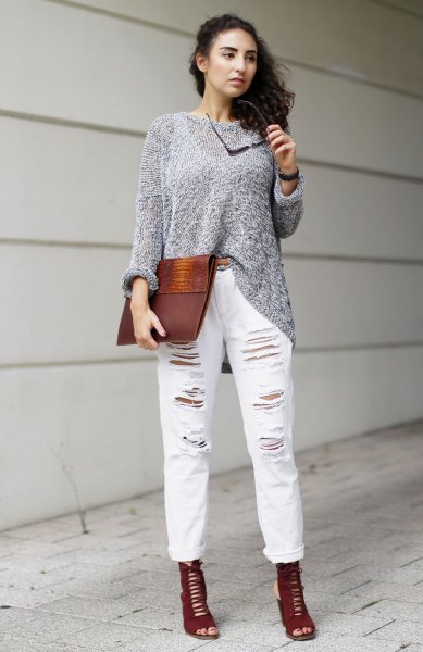 gray sweater with ripped white cuffed boyfriend jeans