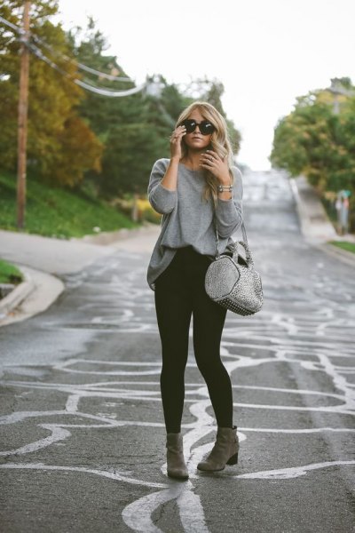 gray sweatshirt with black skinny jeans and ankle boots
