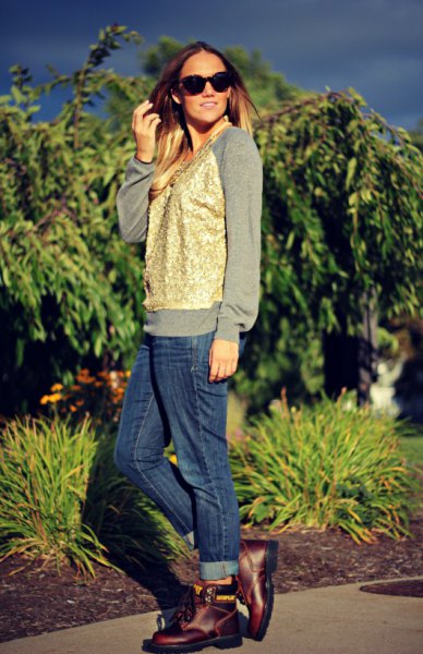 gray sweatshirt with gold waistcoat and blue cuffed jeans