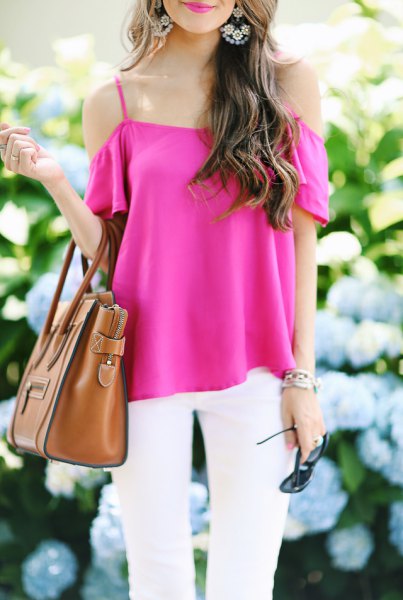Hot pink cold shoulder blouse with white jeans and brown handbag