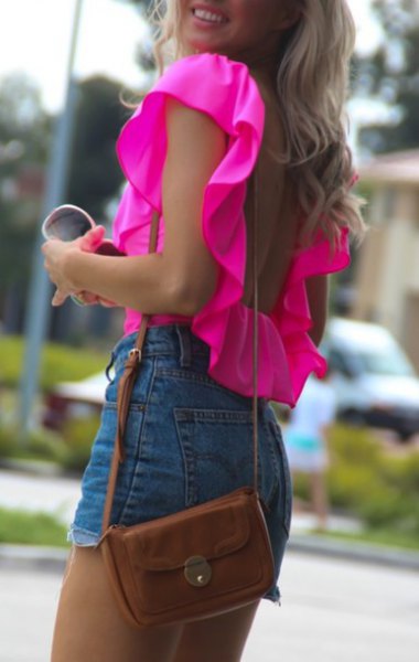 Pink sleeveless blouse with ruched shoulders and high-rise denim shorts
