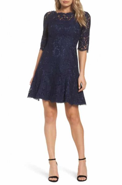 Dark lace dress with a flared silhouette and open ankle strap heels