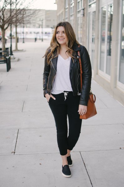 Leather jacket with white V-neck t-shirt and black jogger jeans