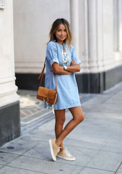 Light blue and white denim mini sheath dress with a brown suede shoulder bag