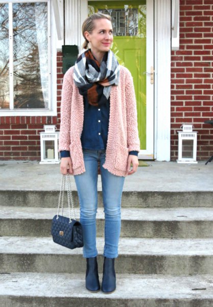 light gray fluffy cardigan with blue jeans and leather boots