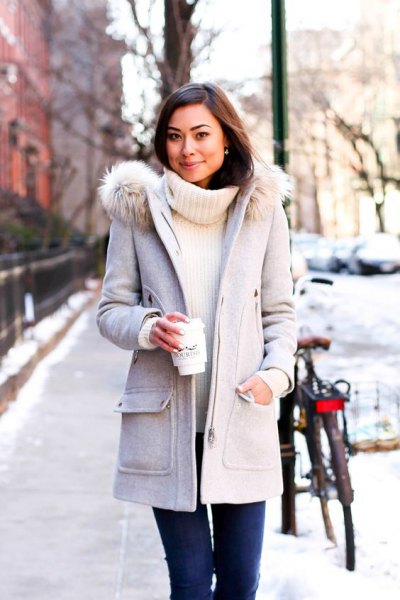 light gray long winter coat with white ribbed turtleneck sweater