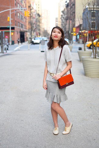 Light gray sweater with matching knee-length skirt with ruffled hem