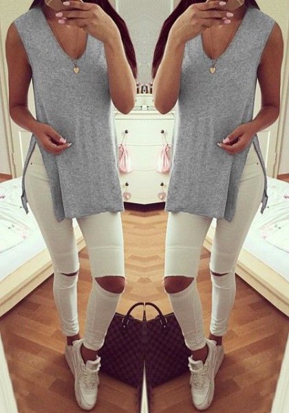 Light gray V-neck shirt with side slits and white ripped jeans