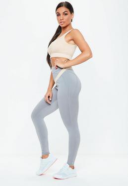 light pink crop top with gray seamless high waisted leggings and white sneakers