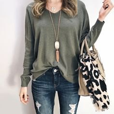 Long sleeve relaxed fit V-neck top with ripped skinny jeans and zebra print tote bag