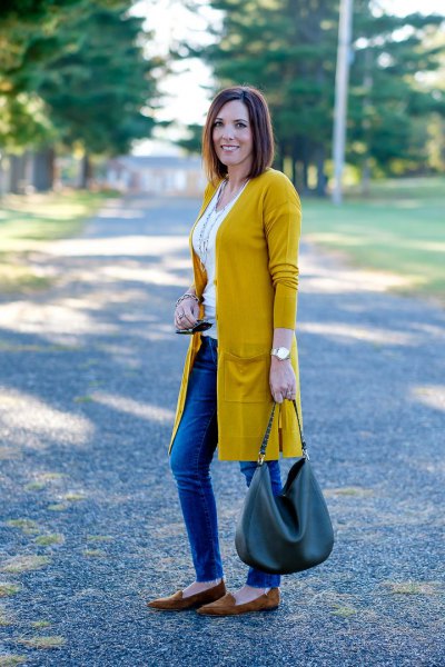 Longline mustard yellow cardigan with white tank top and blue jeans