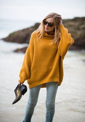 Chunky rib knit turtleneck sweater paired with light gray slim fit jeans