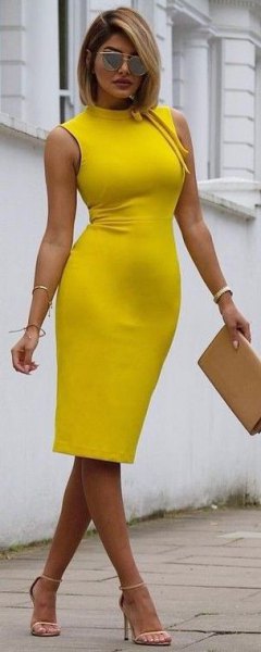 Sleeveless bodycon yellow high neck midi dress with mustard
clutch