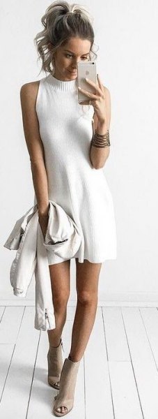 Sleeveless flared sweater dress with high neck and open toe ankle
boots