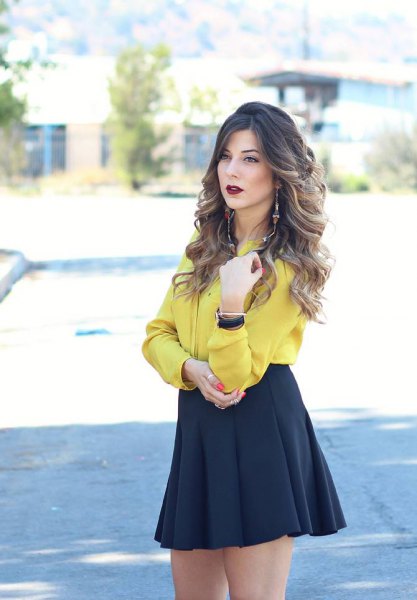 Mustard button down blouse and black high waisted skater skirt