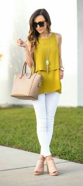 Mustard sleeveless top paired with white skinny jeans and blush open toe boots