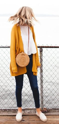 Mustard yellow long knit cardigan with chiffon blouse and ankle jeans
