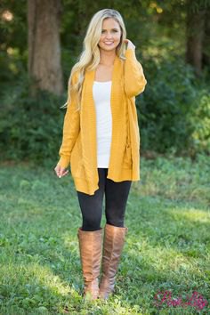 Mustard yellow longline pullover jacket with brown knee high leather boots