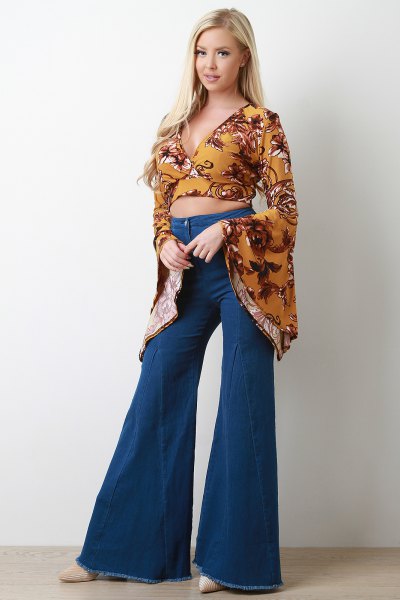 Mustard yellow printed cropped blouse with bell sleeves and flared jeans