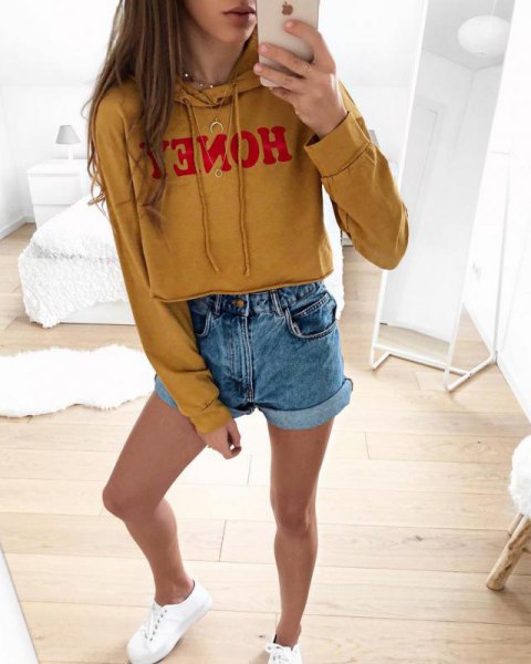 Mustard yellow printed cropped hoodie with blue mini jean shorts