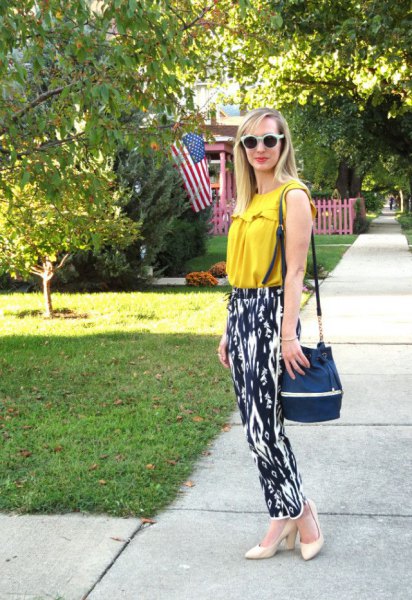 Pair with a mustard yellow sleeveless top and black and white printed relaxed fit trousers to complement