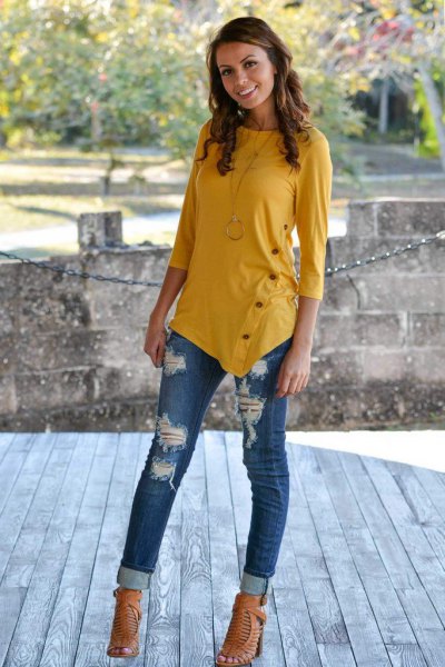 Mustard yellow three-quarter sleeve t-shirt and ripped cuffed jeans