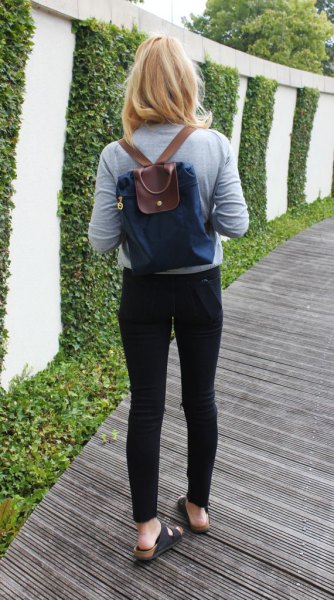 navy blue and brown backpack purse with gray long sleeve t-shirt