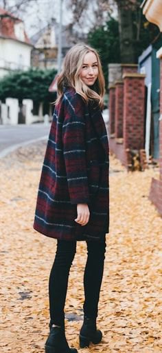 Navy blue and red plaid coat with black skinny jeans and boots