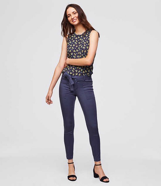 Navy blue and red printed sleeveless blouse with blue chinos
