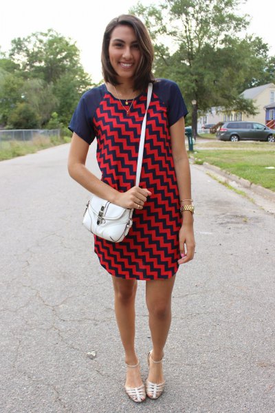 Navy blue and red zigzag mini shift dress with silver strappy
sandals