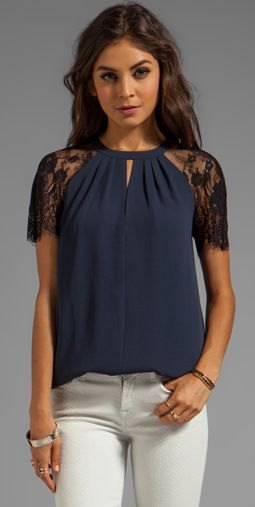 Navy blue short-sleeved lace blouse with white skinny jeans
