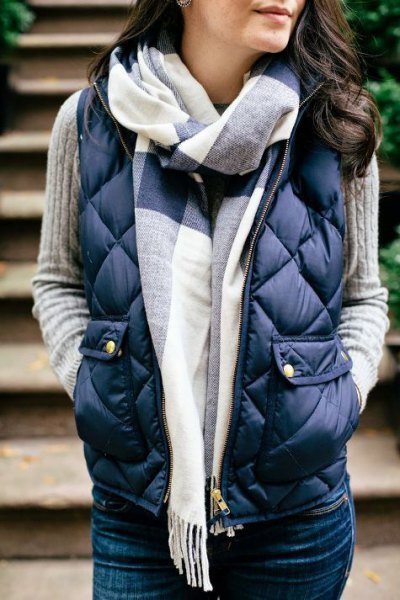 dark blue quilted down vest with gray rib knit sweater