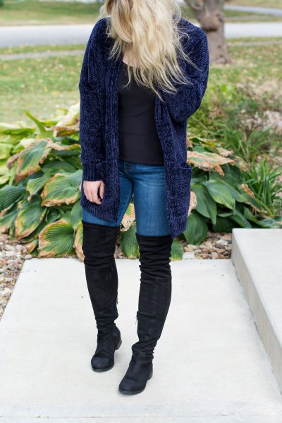 Navy blue ribbed cardigan with skinny jeans and thigh high boots