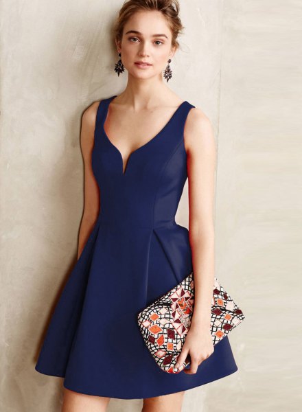 Navy blue V-neck flared mini dress with floral print clutch