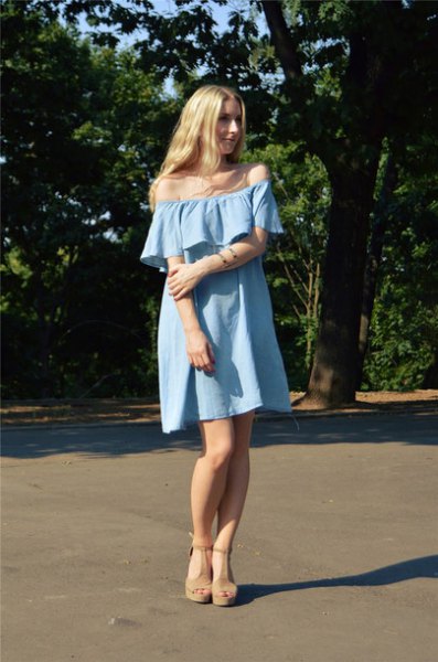 Off-the-shoulder, light blue mini sheath denim dress with heeled sandals
