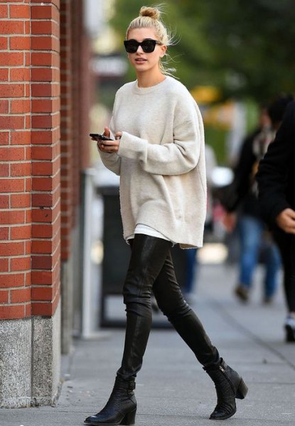 cream oversized knit sweater with black leather leggings