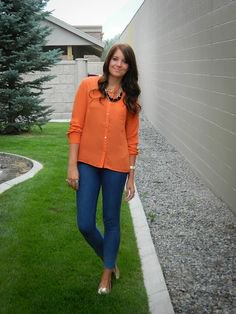 Orange button down shirt, blue slim fit jeans and metallic shoes